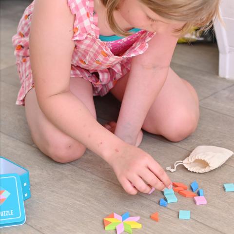 A child puts together a mosaic puzzle