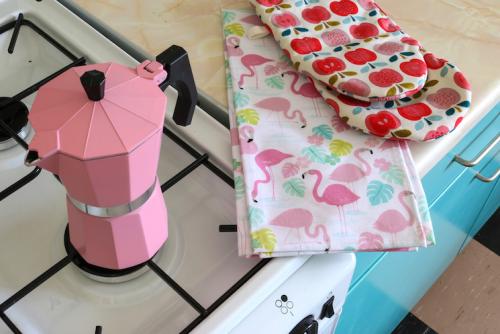 pink coffee maker and tea towel from dotcomgiftshop